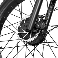 Close-up of the Shengmilo S700 PRO front disc brake rotor and caliper.